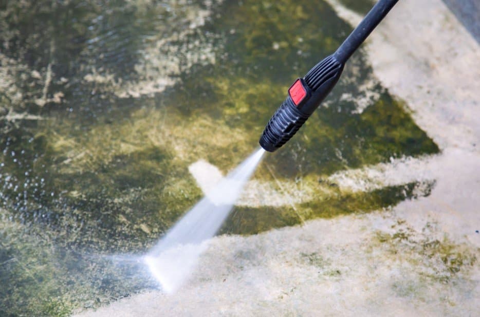 Removing moss buildup with pressure washing